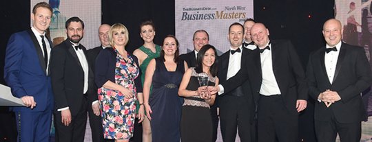 Formally dressed people collecting an award