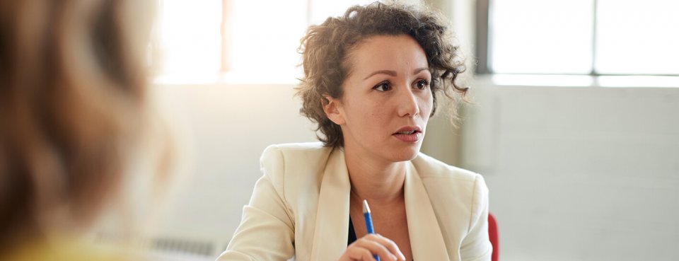 Woman discussing redundancy pay with employees