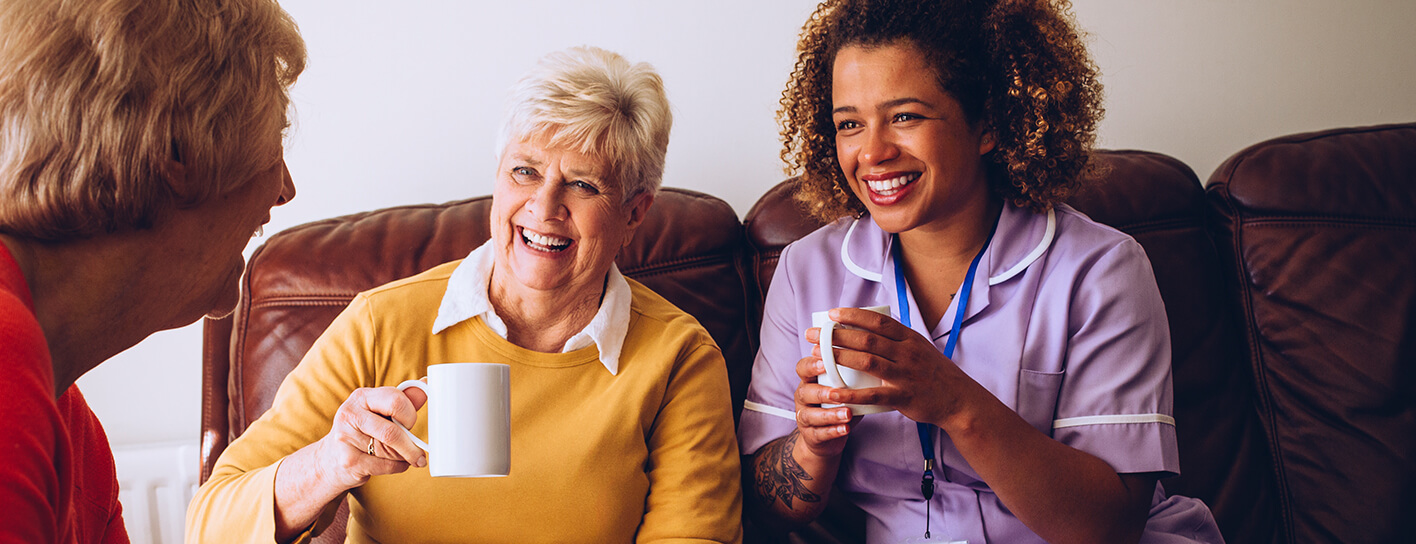 Nurse laughing with elderly people