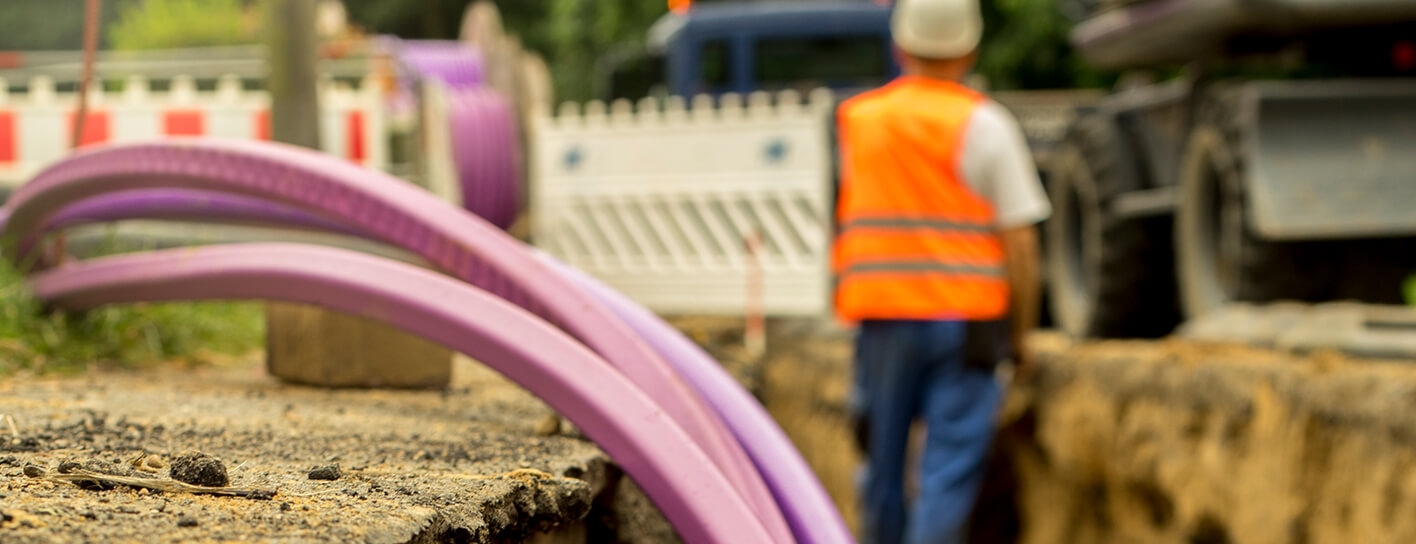 Construction worker in a dug up road