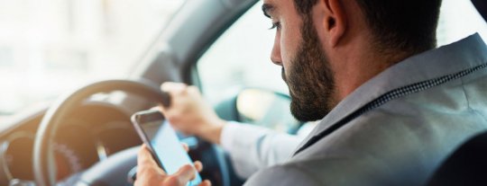 Man using a mobile phone in car