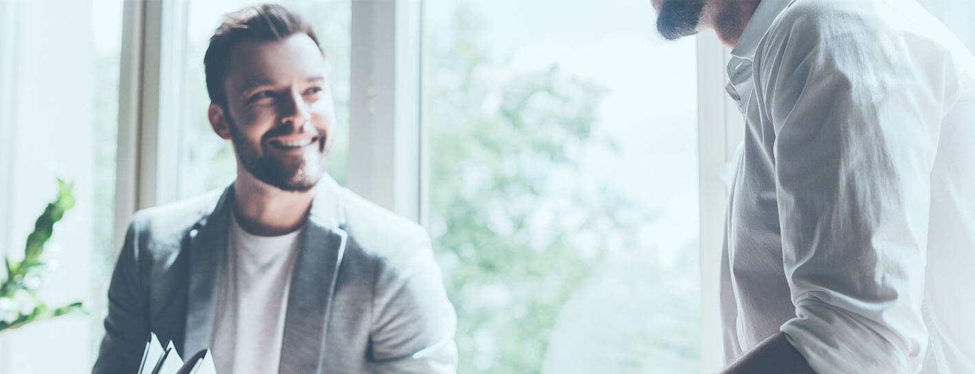 Two men smiling