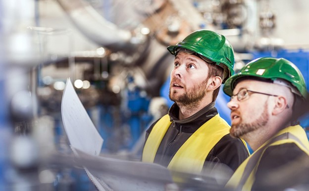 A HSE inspector conducting a health and safety inspection of a workplace