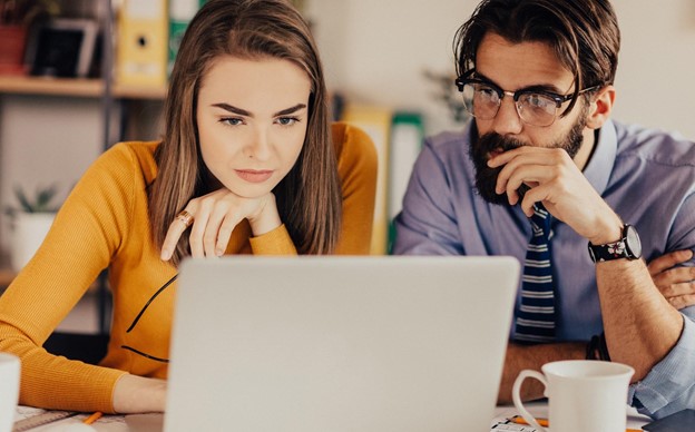 A business owner and employee choosing a suitable HR software package