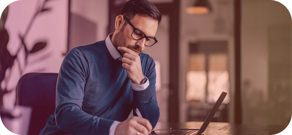A man working on a laptop at a desk.