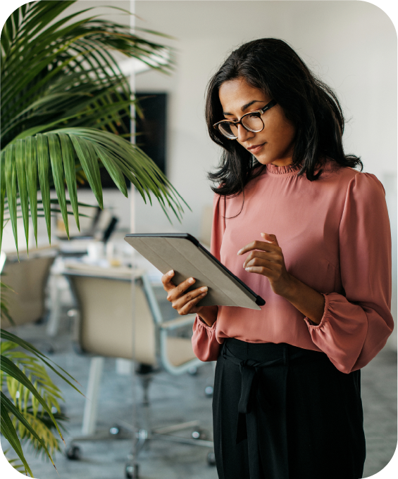 Woman wearing glasses using a tablet in the workplace