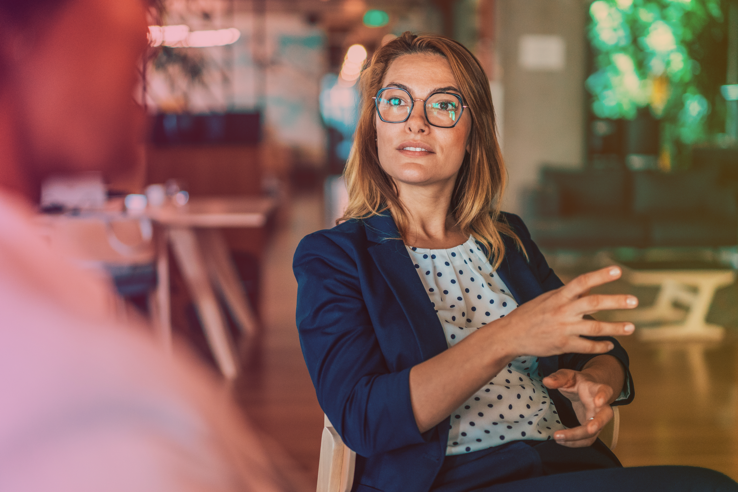 A business woman having a serious conversation about sick pay.